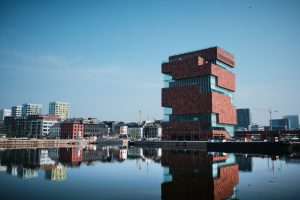 concrete buildings near body of water