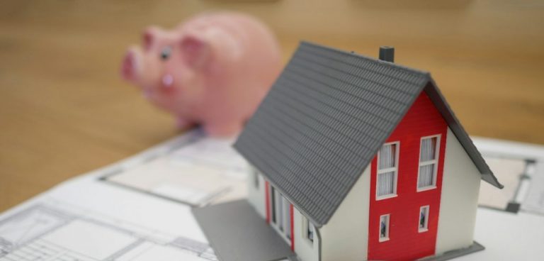 white and red wooden house beside grey framed magnifying glass