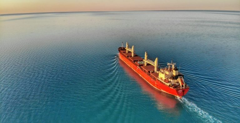 red and white cargo ship at middle of ocean