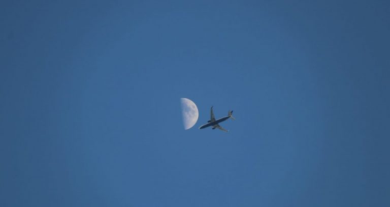 white airplane flying in the sky during daytime