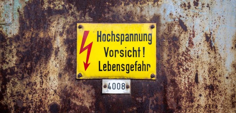 yellow voltage metal sign