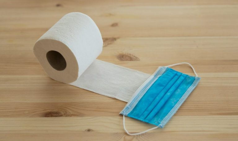 white toilet paper roll on brown wooden table