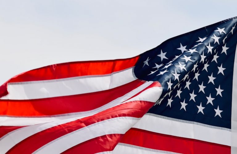 a large american flag flying in the sky