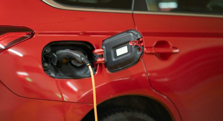 red car with yellow hose
