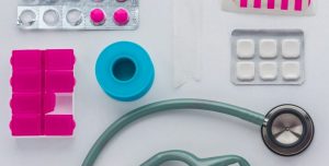 green and black stethoscope on white printer paper