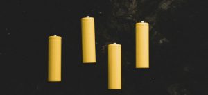 yellow pillar candles on black surface
