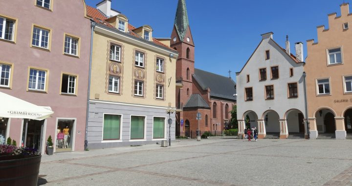 a cobblestone street lined with tall buildings
