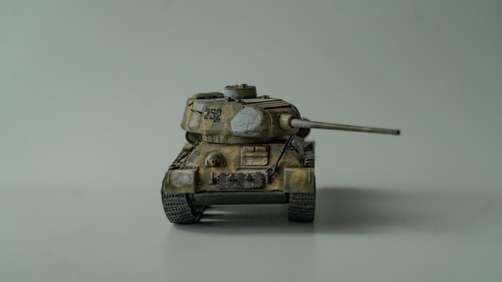 A small toy tank sitting on top of a table