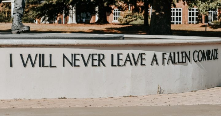 a man riding a skateboard down a sidewalk
