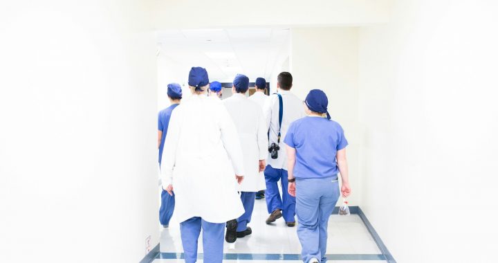 group of doctors walking on hospital hallway