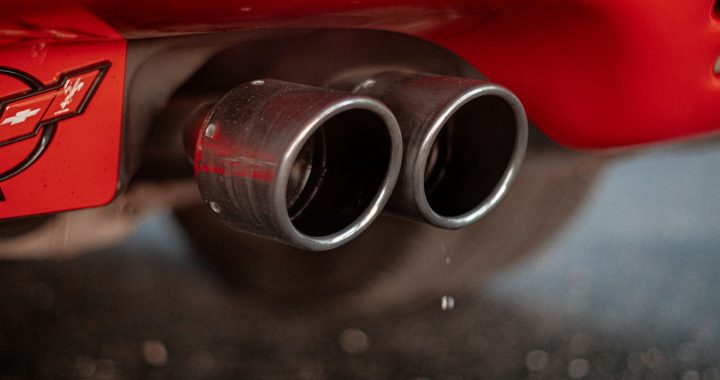 a close up of the exhaust pipes on a red sports car