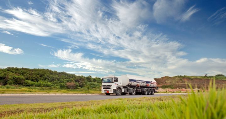 white and black storage truck on gray asphalt road