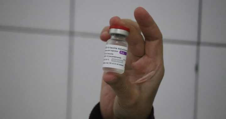 person holding white plastic bottle