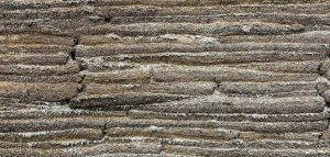 a close up of a rock formation with grass growing on top of it