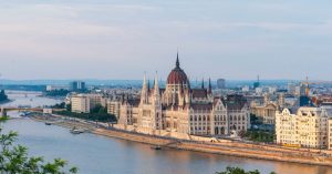 brown concrete building near body of water during daytime
