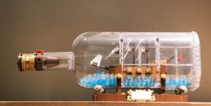 Lego ship in a bottle with blue water