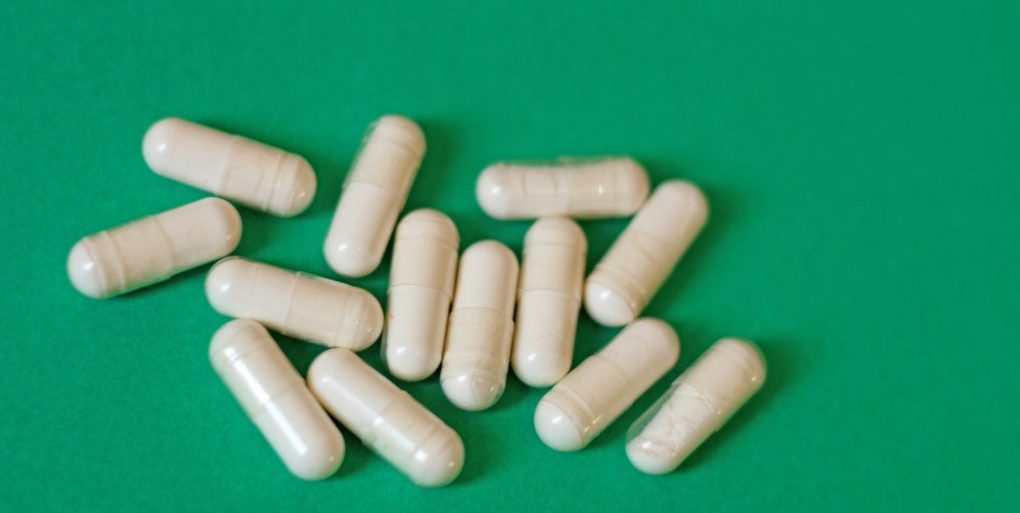 A pile of pills sitting on top of a green table