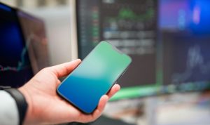 a person holding a cell phone in their hand