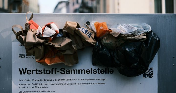 a bunch of bags sitting on top of a sign