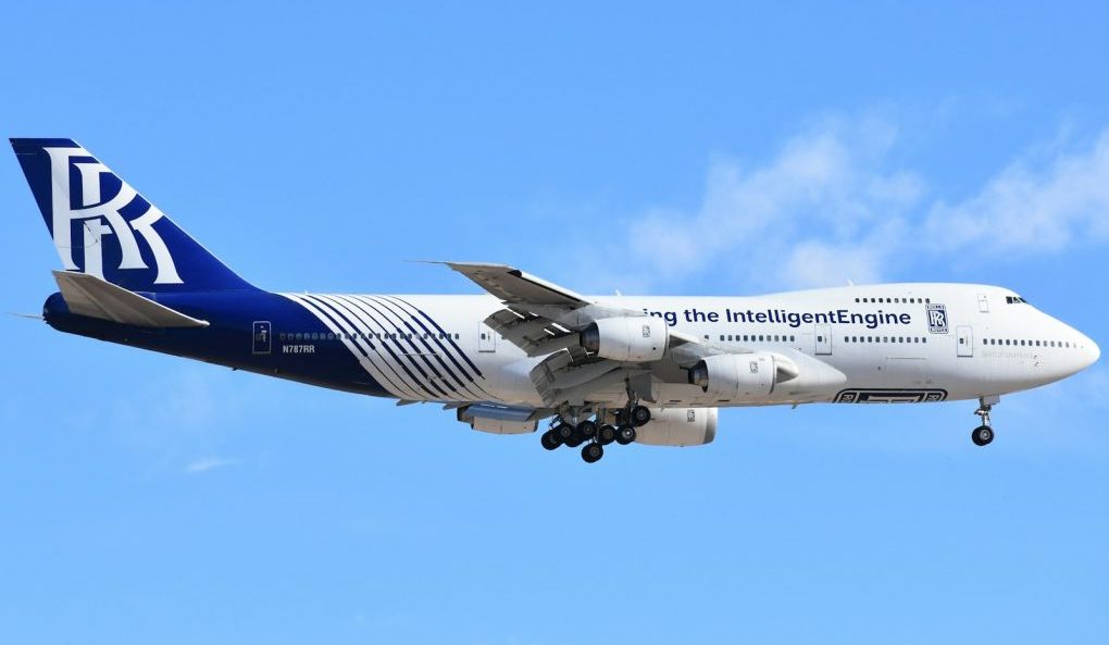 A large jetliner flying through a blue sky