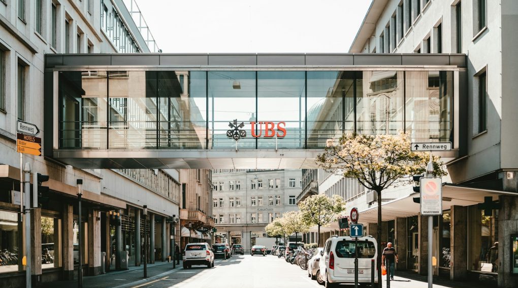 UBS logo on glass bridge wall during daytime