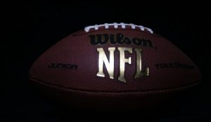 a close up of a football on a black background