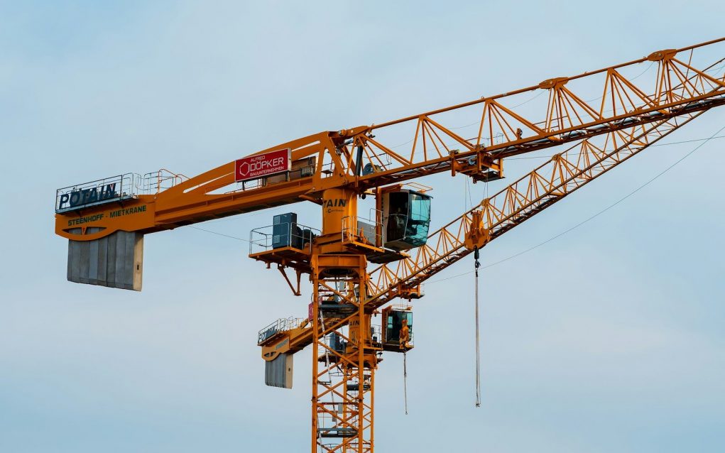 Photo by Jahanzeb Ahsan a yellow crane with a red sign on it