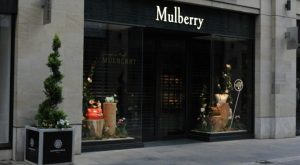 Mulberry luxury store facade with elegant window displays and topiary