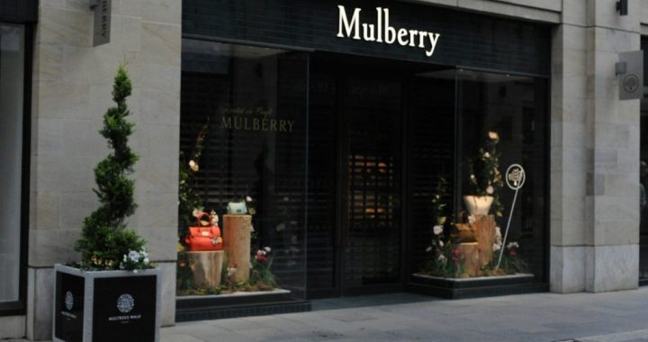Mulberry luxury store facade with elegant window displays and topiary
