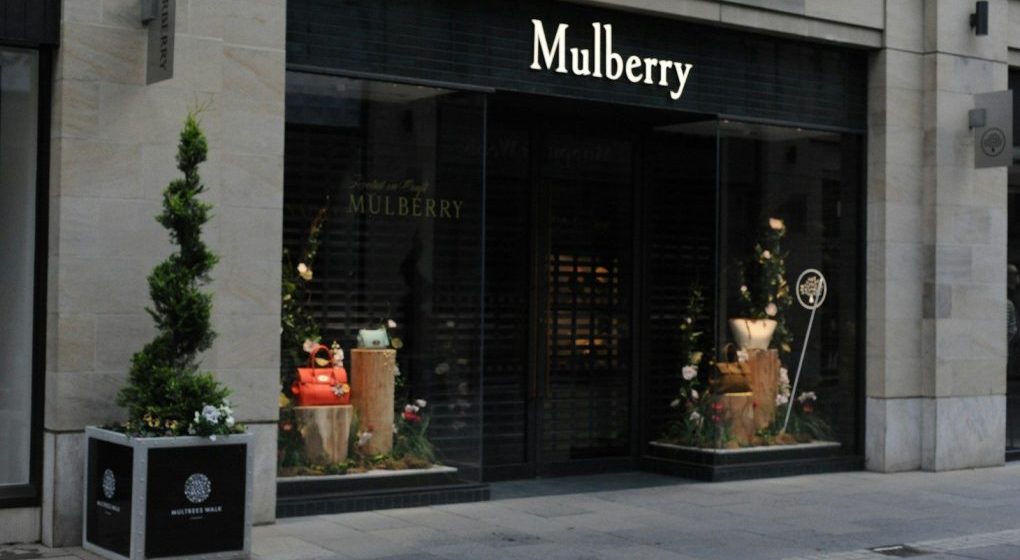 Photo by Chloë Forbes-Kindlen Mulberry luxury store facade with elegant window displays and topiary