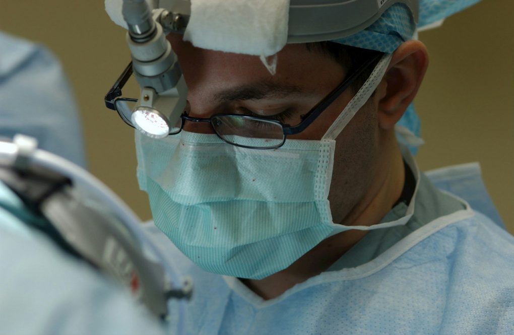 Photo by National Cancer Institute man in blue and white collared shirt wearing green face mask