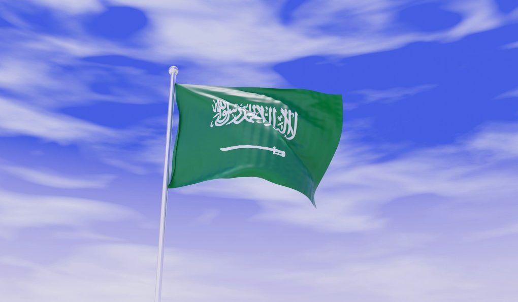 Photo by Akhilesh Sharma a flag flying in the wind with a blue sky in the background